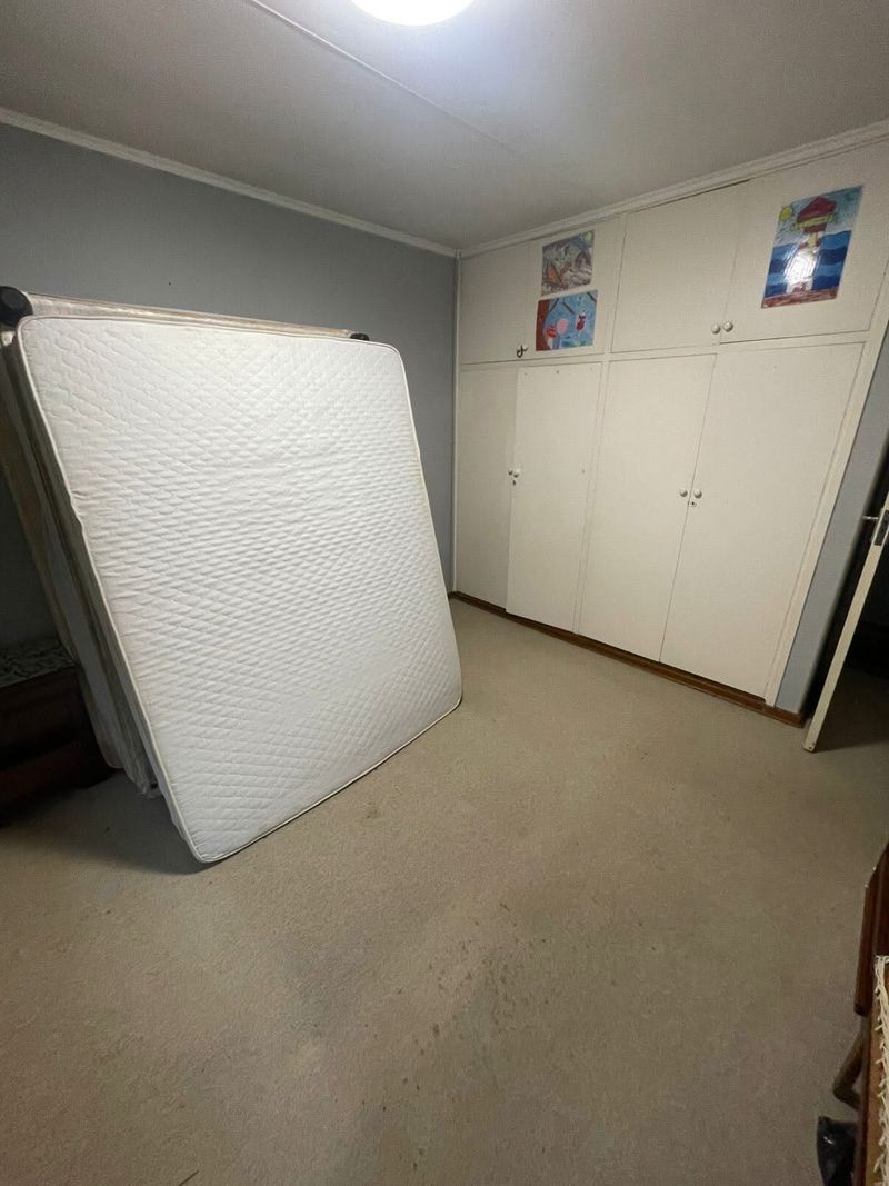 Bedroom empty apart from a mattress after the clear-out