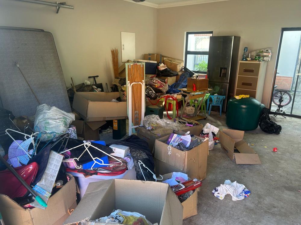 Garage full of boxes and furniture before the clear-out