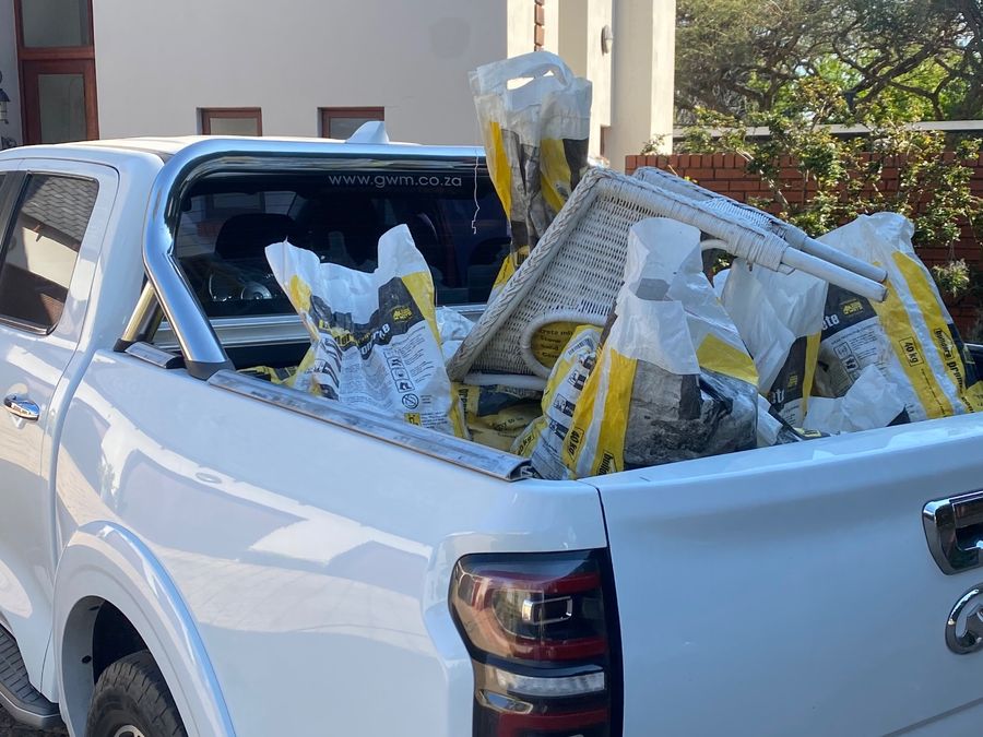Bakkie loaded with rubble bags and furniture