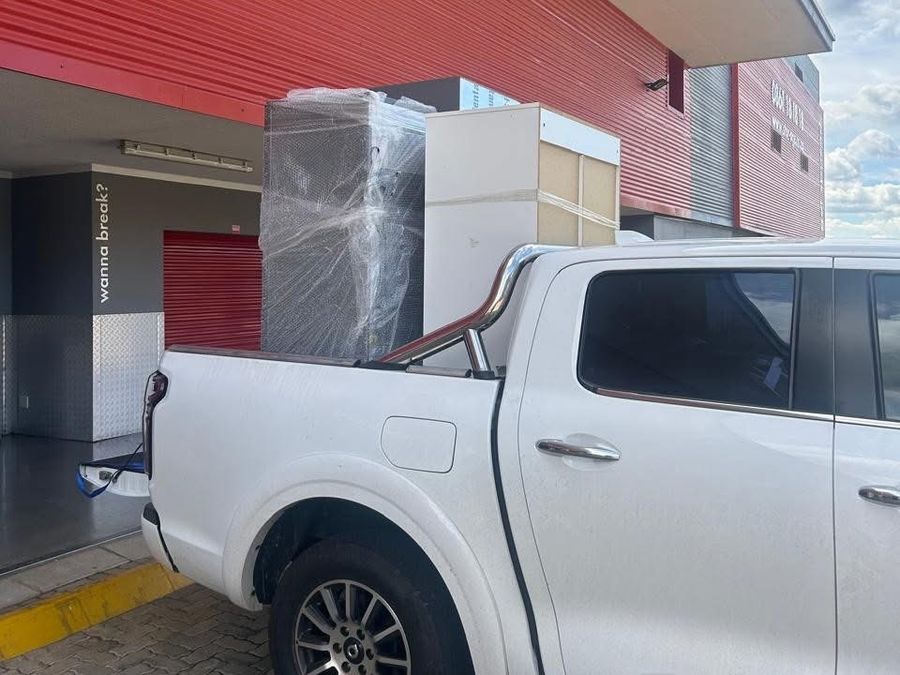 Wrapped appliances loaded on a bakkie at a storage facility