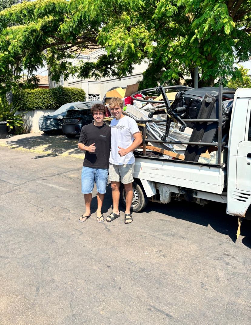 Christo and Juan standing next to a loaded truck